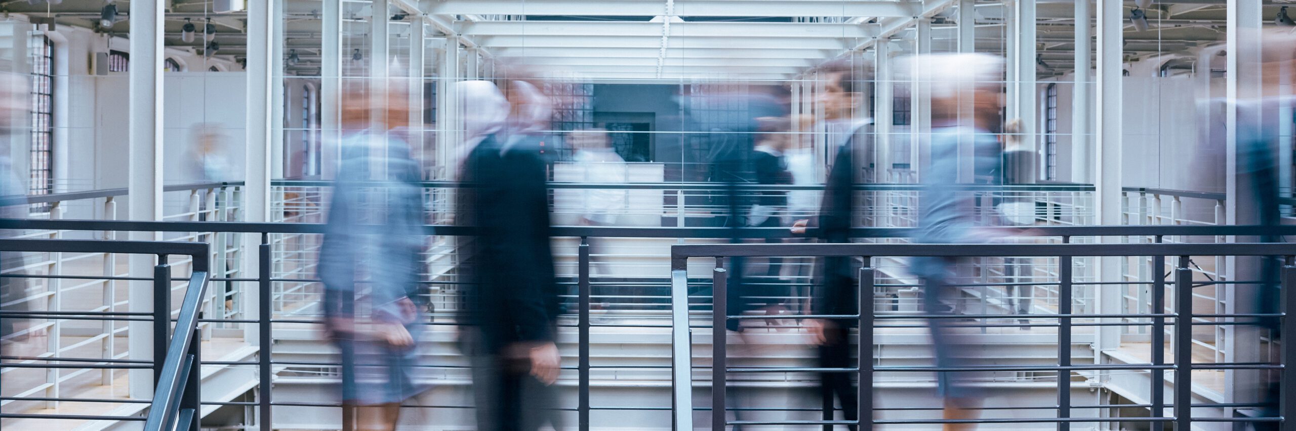 Business people talking in office corridor, industrial interior, panorama